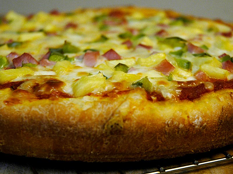 A deep dish Hawaiian pizza with ham, mushroom, pineapple and red bell pepper.   Another idea from Cooks Illustrated, this pizza is cooked in a spring-form cake pan at a lower temperature (400 F) than regular pizza (550 F) and the dough is made with milk instead of water.  Milk has a certain protein that helps to break down gluten structure, making for a softer dough.  Really great pizza!