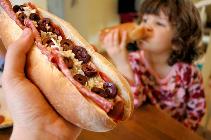 Alexandra and I enjoy a couple of sub sandwiches on a Saturday.  Super!