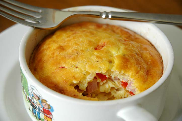 A western souffle.  A western omelet is one of my favourite breakfasts and today I decided to bake it instead of pan-fry.  I sauteed the onion, red pepper and ham in a bit of butter first to soften it, added a bit of cream to cool it donw, then stirred in two eggs, salt and pepper, then loaded the whole thing in the oven-proof cup to bake at 350 for about 20 minutes.  It actually souffleed (puffed up) really nicely.  Delicious!